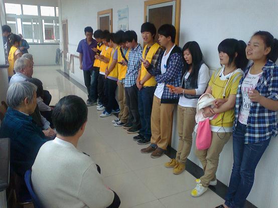 图为：同学们正在给老人表演节目