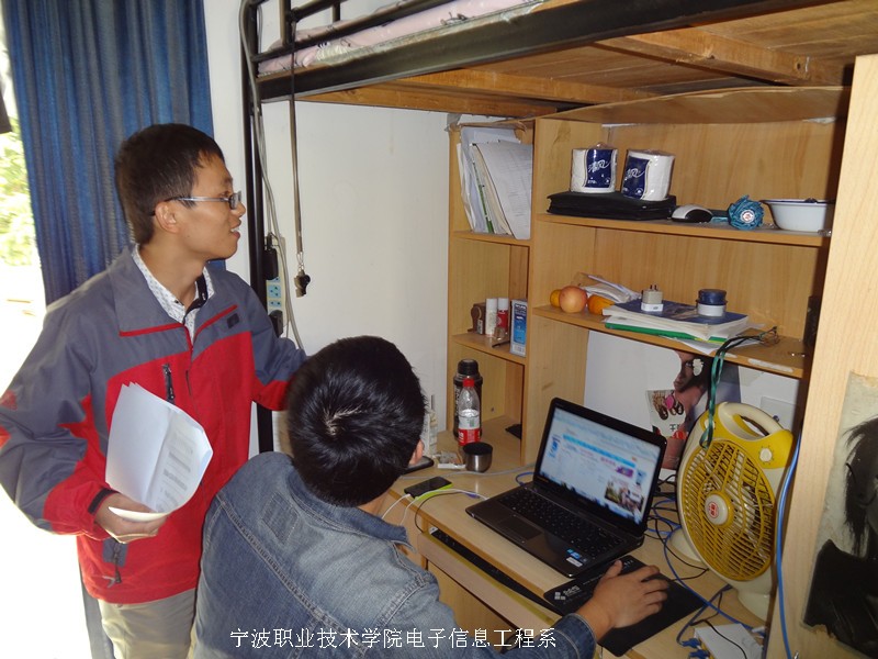 图为：胡国伟老师细心的为同学提出整改要求 